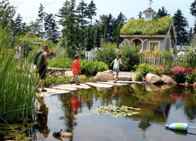 A group of people exploring the Coastal Maine Botanical Gardens, located near East Boothbay, Maine