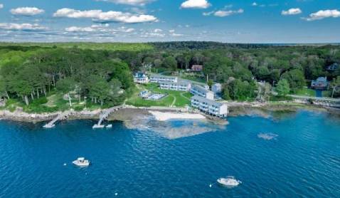Kayaks on beach at sunset.