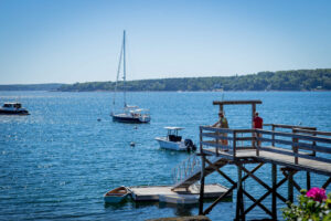 People on a dock, a great place to look up what to do in Boothbay Harbor.